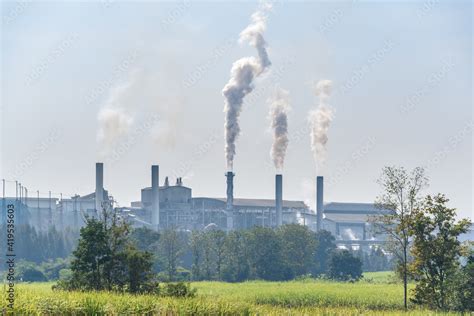 White Smoke Comes Out From Smokestacks Or Exhaust Pipes Factory