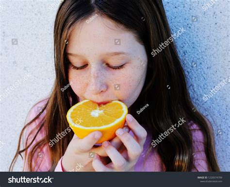 Teenage Girl Holding Orange Fresh Fruit Stock Photo 1220574799