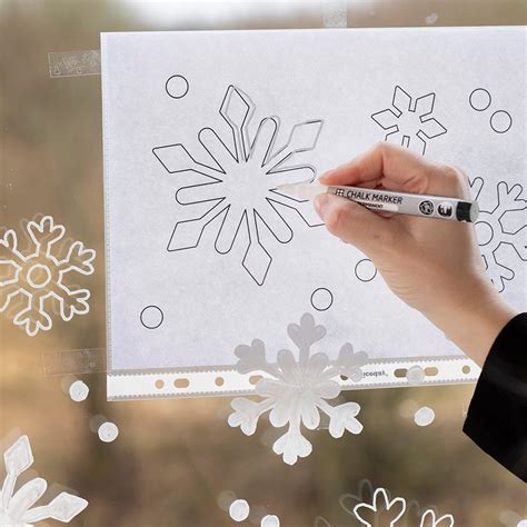 Snowflake window decoration with chalk markers.