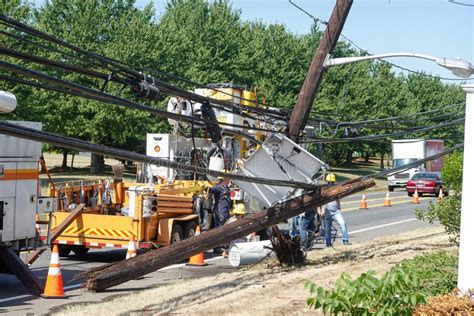 Electric Utility Repair Crew On The Scene Of A Broken Wooden Utility