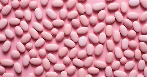 Premium AI Image | dozens of pink pills on a surface in the style of minimalist simplicity of forms