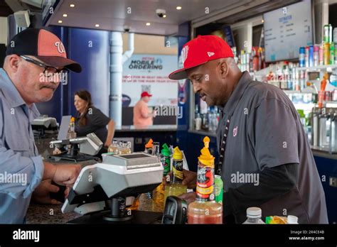 Washington Dc A Worker Sells Drinks From A Concessions Stand During A Baseball Game At