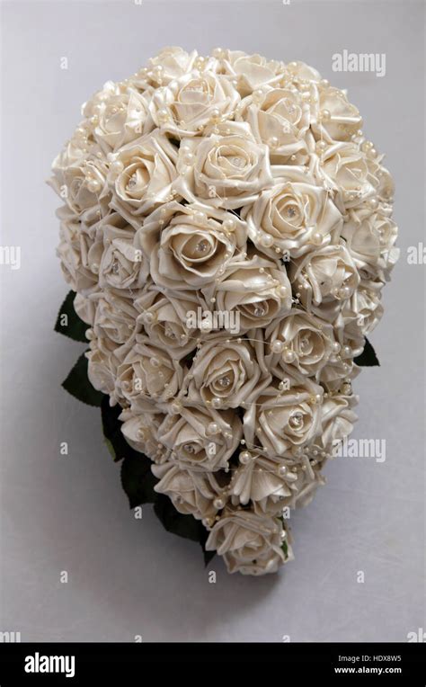 A Wedding Bouquet Made Of Whitecream Silk Fabric Roses And Seed Pearls