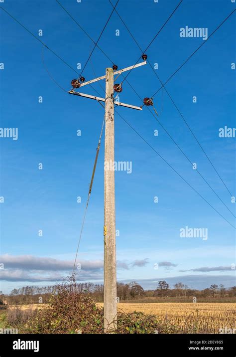 Wooden Telegraph Poles With Wires And Insulators Against A Clear Blue