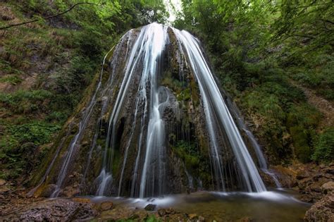 Premium Photo | A waterfall in a mountain forest