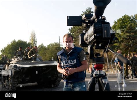 TV Reporter Wearing Protective Flak Jacket Marked TV Reporting Stock