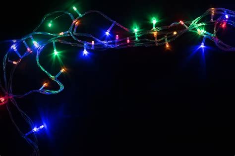 Premium Photo Christmas Background With Glowing Garlands On Black