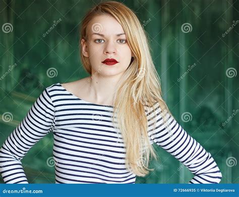 Blonde Avec Les Lèvres Rouges Dans La Chemise Rayée Sur Un Fond Vert