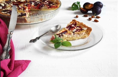 Premium Photo A Piece Of Plum And Almond Frangipane Tart On A Table