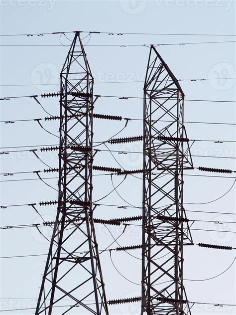 Two High Tension Power Line Towers Against Blue Sky 42554948 Stock