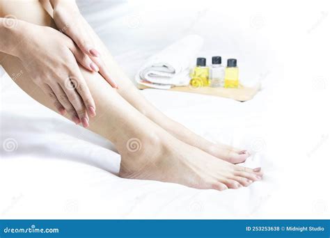 Massage Therapist S Hand Massages Young Woman S Calf Muscles In Spa