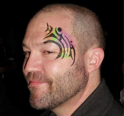 A Man With A Tattoo On His Face