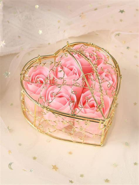 A Heart Shaped Box Filled With Pink Roses