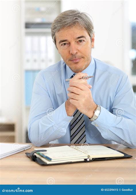 Portrait Of Mature Businessman Sitting At Office Stock Image Image Of