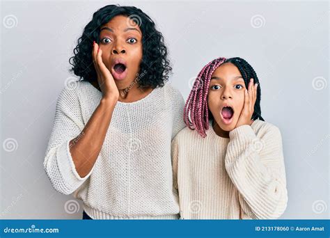 Beautiful African American Mother And Daughter Wearing Casual Clothes And Hugging Afraid And