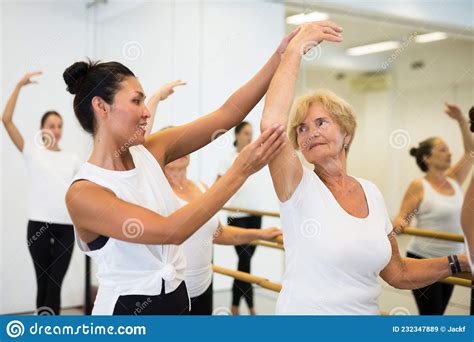 Female Choreographer Helping Tweenagers Make Gymnastic Bridge In Royalty-Free Stock Photo ...