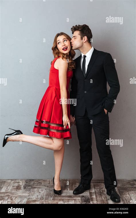 Full Length Portrait Of An Attractive Smiling Couple Dressed In Formal