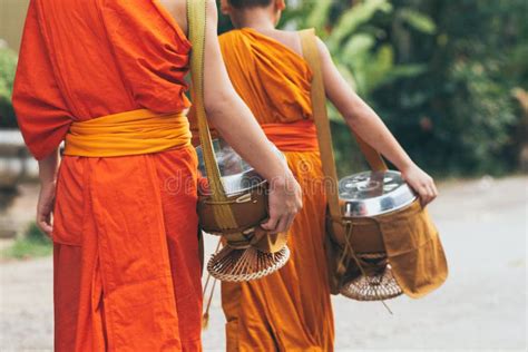 Laotian People Making Offerings To Buddhist Monks During Traditional