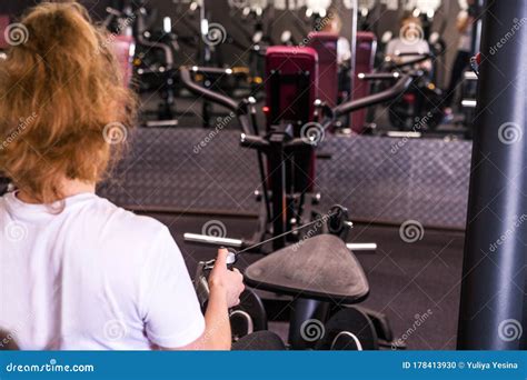 Fitness Caucasian Women Performing Doing Exercises Training With Rowing