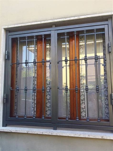 A Window With Iron Bars And Wooden Windowsills On The Side Of A Building