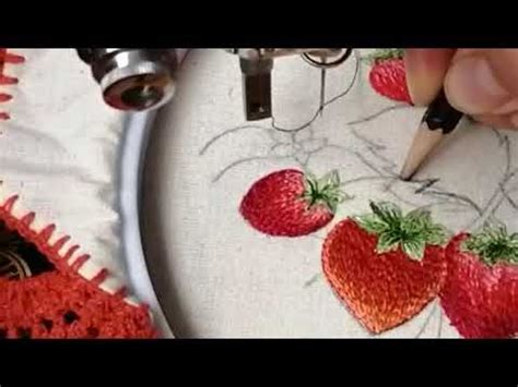 Someone Is Stitching Strawberries On A Piece Of Fabric