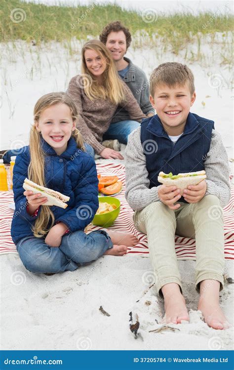 Familia De Cuatro Miembros Feliz En Una Comida Campestre De La Playa