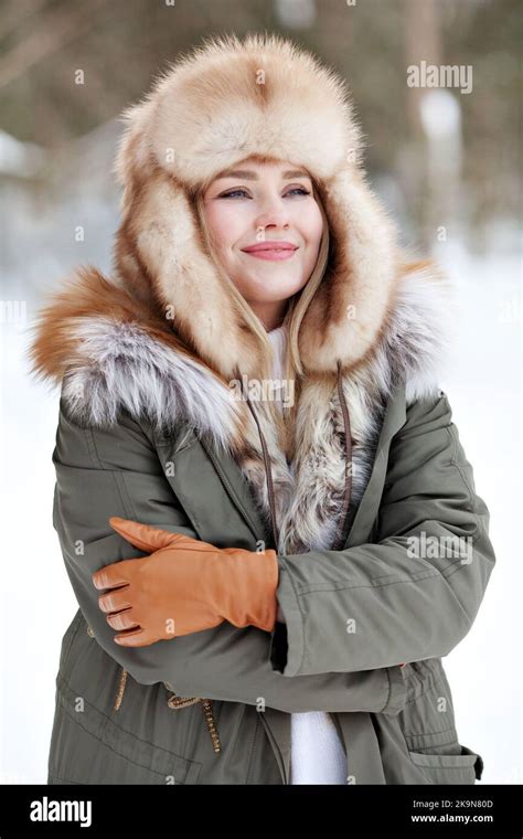 Portrait Of Young Woman In Warm Clothes Wearing Winter Parka Jacket