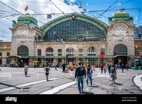 Basel Switzerland , 29 June 2020 : Front view of Basel SBB train station with people going to it ...