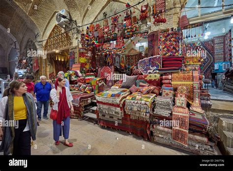 People Walk By A Handicraft Shop In The Vakil Bazaar Shiraz Iran