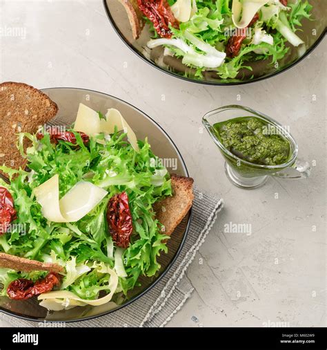 Salad With Frisee Lettuce Sun Dried Tomatoes Cheese Bread Chips And