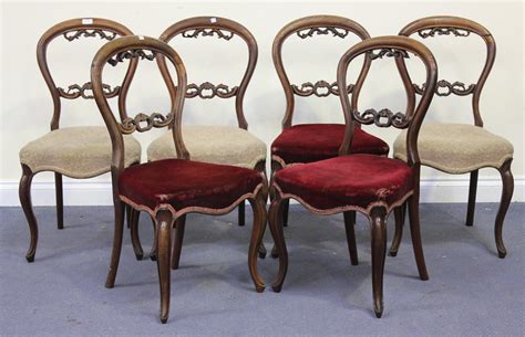 A Set Of Six Victorian Rosewood Balloon Back Chairs With Carved Foliate