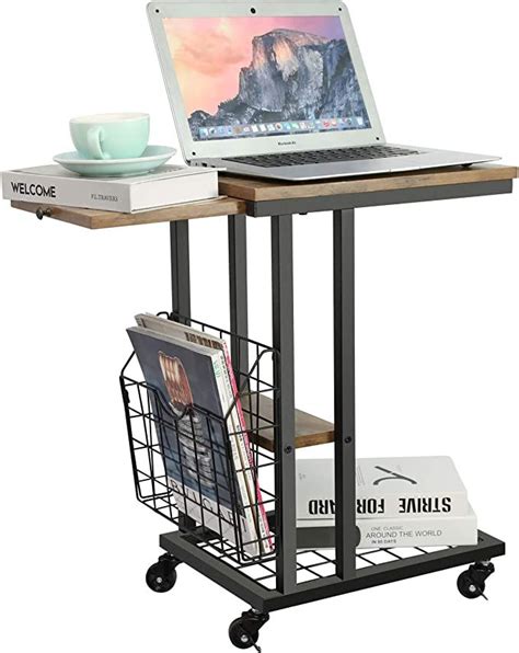 A Laptop Computer Sitting On Top Of A Wooden Table Next To A Magazine