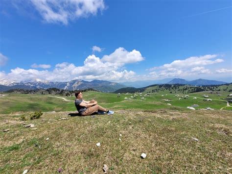 Premium Photo Man Enjoys Views Of The Alpine Village In Mountains