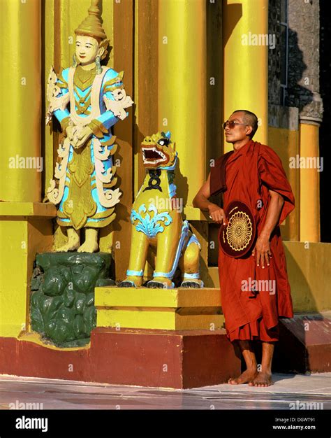 Shwedagon Pagoda Monk Standing Next To A Guardian Figure Rangun