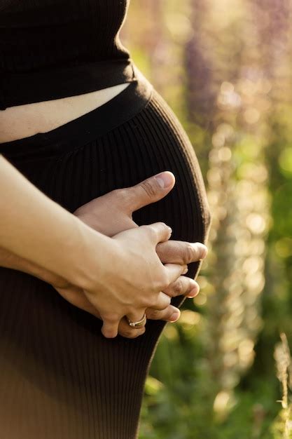 Premium Photo A Pregnant Woman Stands Against The Backdrop Of The