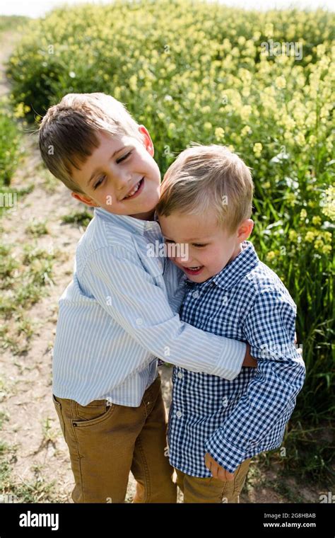 Brothers Hugging in Wildflower Field in San Diego Stock Photo - Alamy