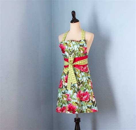 A Dress On A Mannequin In Front Of A Blue Wall With Red Flowers