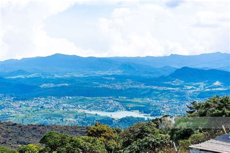 A Scenic View Of The Mountains And Valleys From A Hill Top With Houses