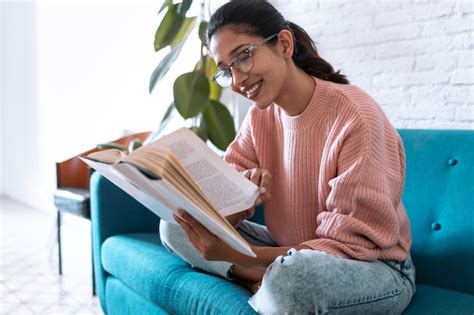 Premium Photo Shot Of Pretty Young Woman Reading A Book While Sitting