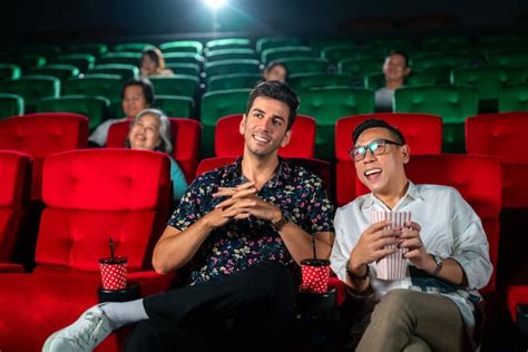 Premium Photo Gay Couple Sweet And Watching Cinema Together On Red Seat In Theater Lgbt Couple