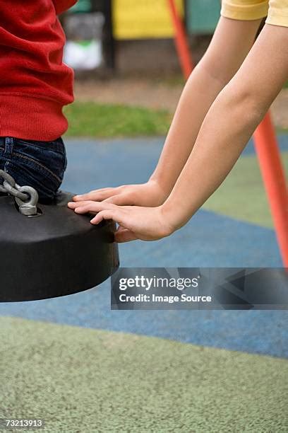 boy pushing girl  swing   premium high res pictures getty