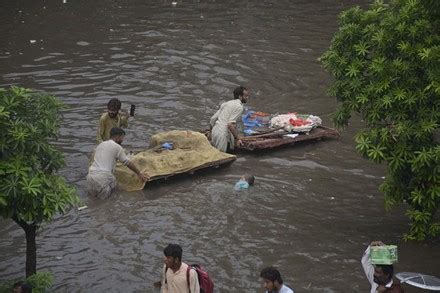 Pakistani Commuters Wade Through Flooded Road Editorial Stock Photo