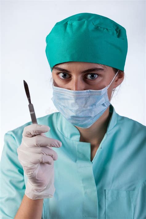 Surgeon With Scalpel Performing Operation In Operation Theater Stock