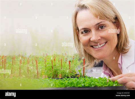 Female Scientist Smiling Near Plants In A Laboratory Stock Photo Alamy