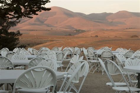 tables and chairs are set up in front of the mountain range for an ...