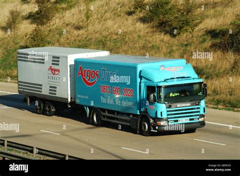 M25 motorway Argos lorry truck towing trailer Stock Photo - Alamy