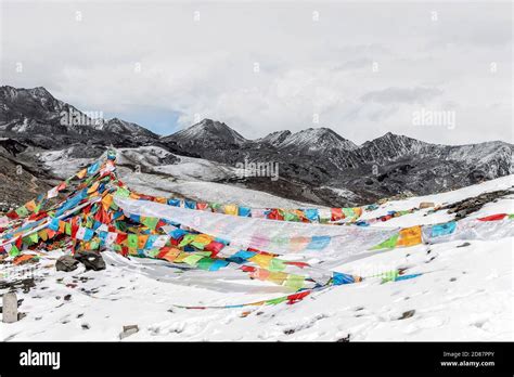 Landscape Of Colorful Buddhist Prayer Flags On Snow Mountain Stock