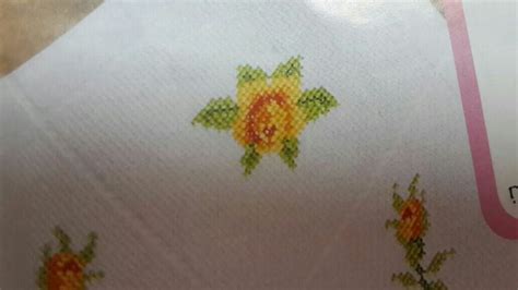 A Close Up Of A Piece Of Fabric With Flowers On It And The Words Cross