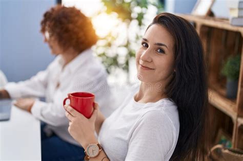 Two Women Mother And Daughter Drinking Coffee Using Laptop At Home