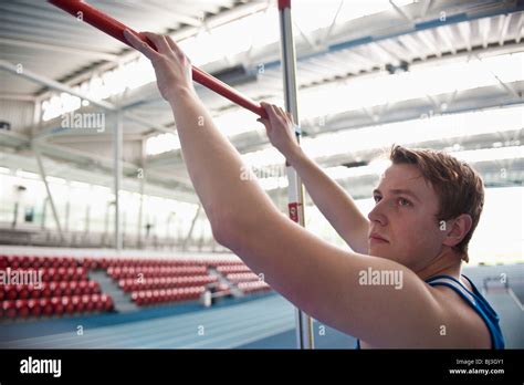 male athlete setting high jump bar Stock Photo - Alamy